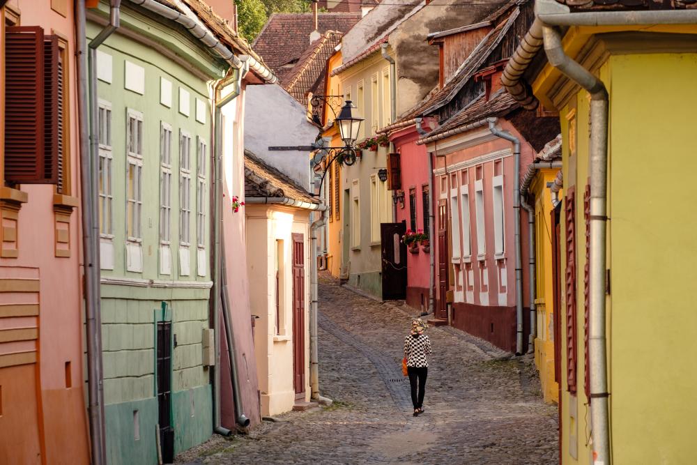 A woman in the medieval streets of Sighi\u0219oara, Romania