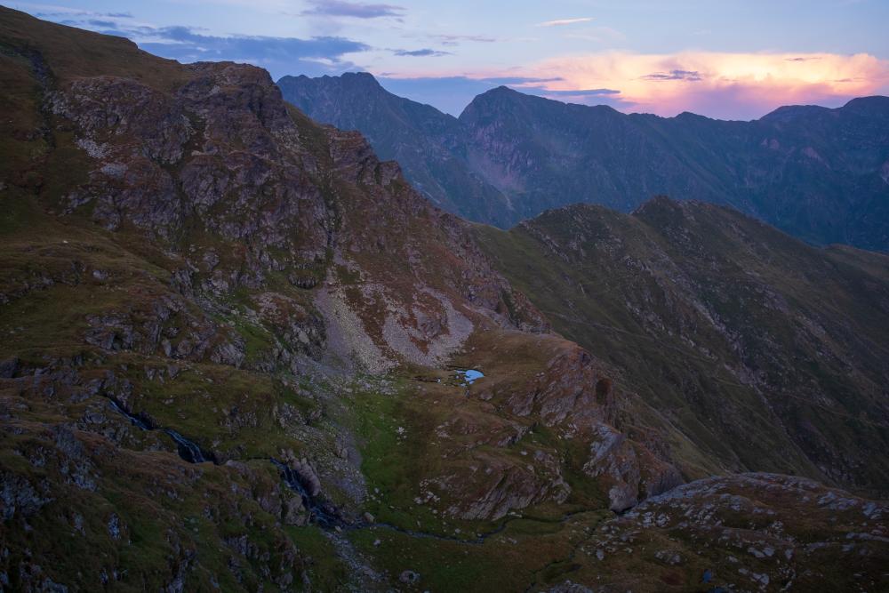Sunset over a waterfall in the Transfăgărășan  Mountains, Romania